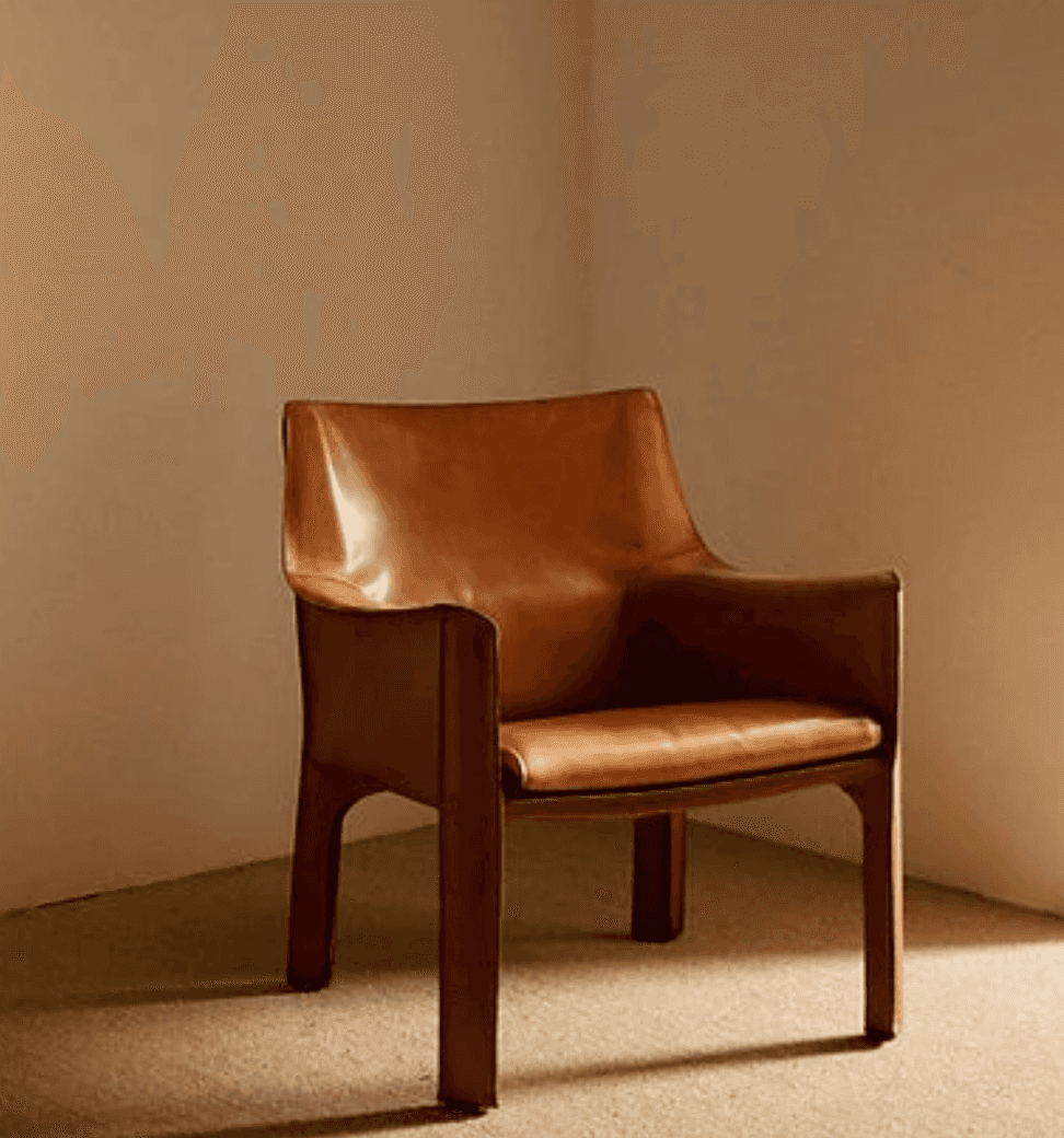A modern armchair fully upholstered in a rich, warm brown leather. The chair features integrated arm… — 3D model