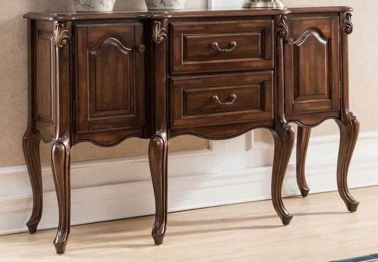 An ornate, dark wood sideboard featuring cabriole legs, intricate carvings, two central drawers with… — 3D model