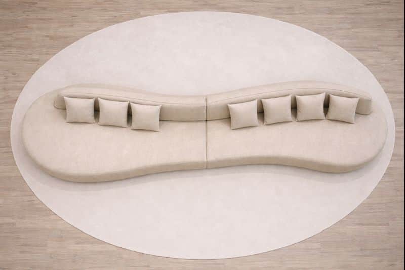 A large, modular, curvilinear sofa with a neutral-toned fabric upholstery. The sofa is composed of m… — 3D model