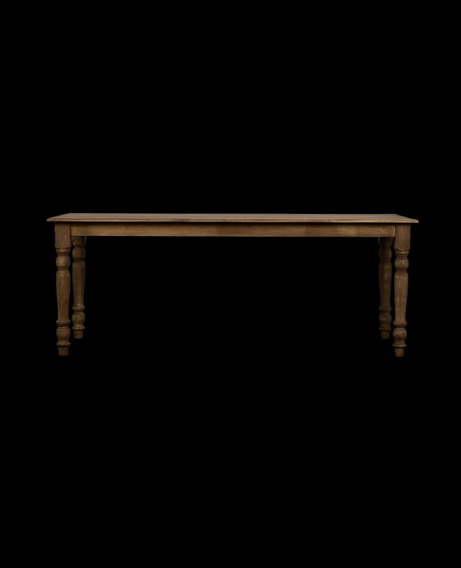 A long, rectangular dining table with four turned legs. The tabletop appears to be solid and has a n… — 3D model