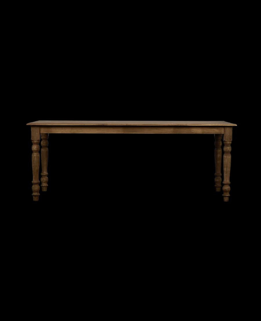 A long, rectangular dining table with four turned legs. The tabletop appears to be solid and has a natural wood grain visible. The legs have a distinct baluster shape, with bulbous sections and turned details, indicative of a traditional or farmhouse style. — 3D model