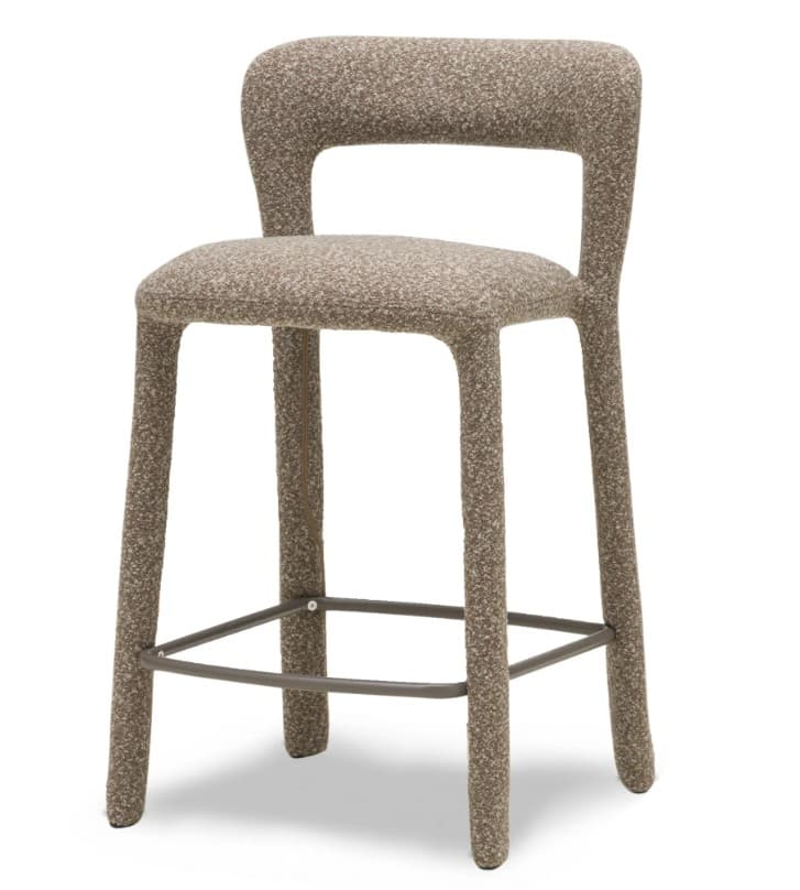 A contemporary counter-height bar stool fully upholstered in a textured, light greyish-beige fabric, featuring an integrated open backrest, a comfortable seat, and a circular metal footrest. — 3D model