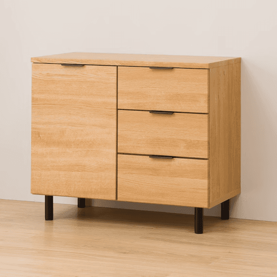 A modern, light wood-look credenza featuring one cabinet door and three drawers, supported by black… — 3D model