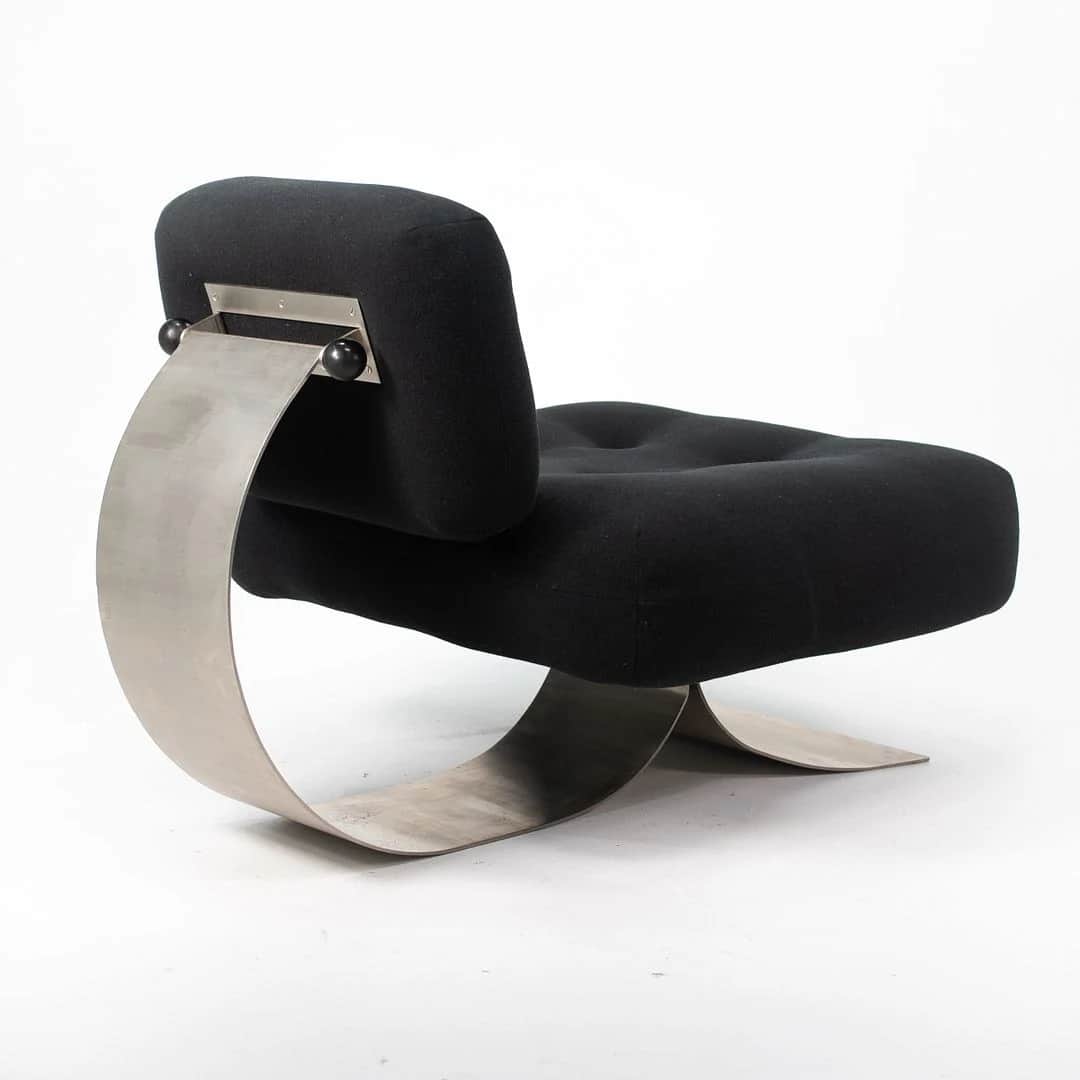 A postmodern lounge chair featuring a distinctive sculptural brushed metal base supporting a plush,… — free STL 3D model