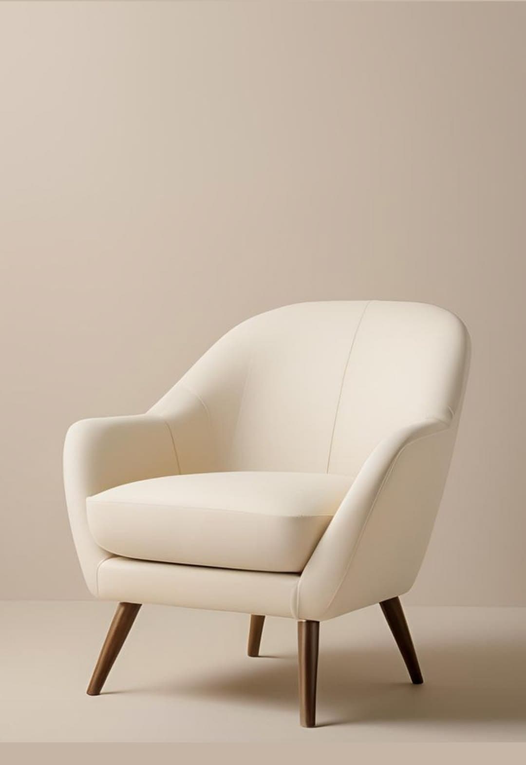 A cream-colored upholstered armchair with a rounded back, integrated arms, a removable seat cushion, and four tapered dark wood legs, presented against a light background. — 3D model