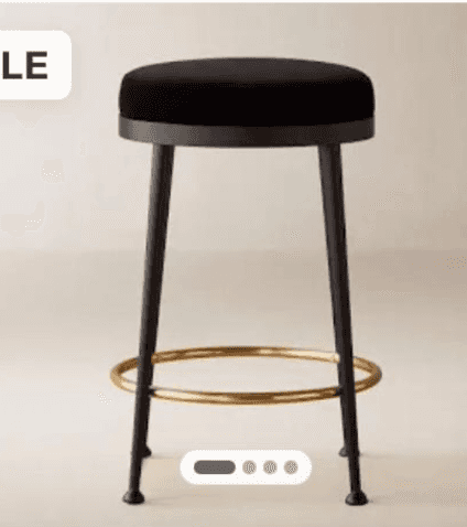A modern bar stool featuring a round, thickly upholstered black velvet or fabric seat. It stands on… — 3D model