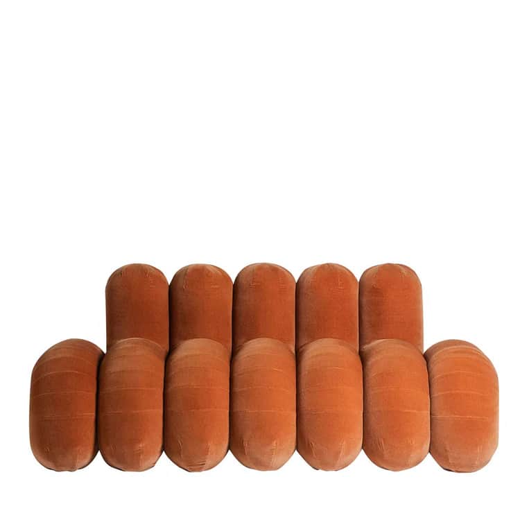 A modular sofa composed of rounded, cylindrical-shaped upholstered modules arranged in two rows. The… — 3D model