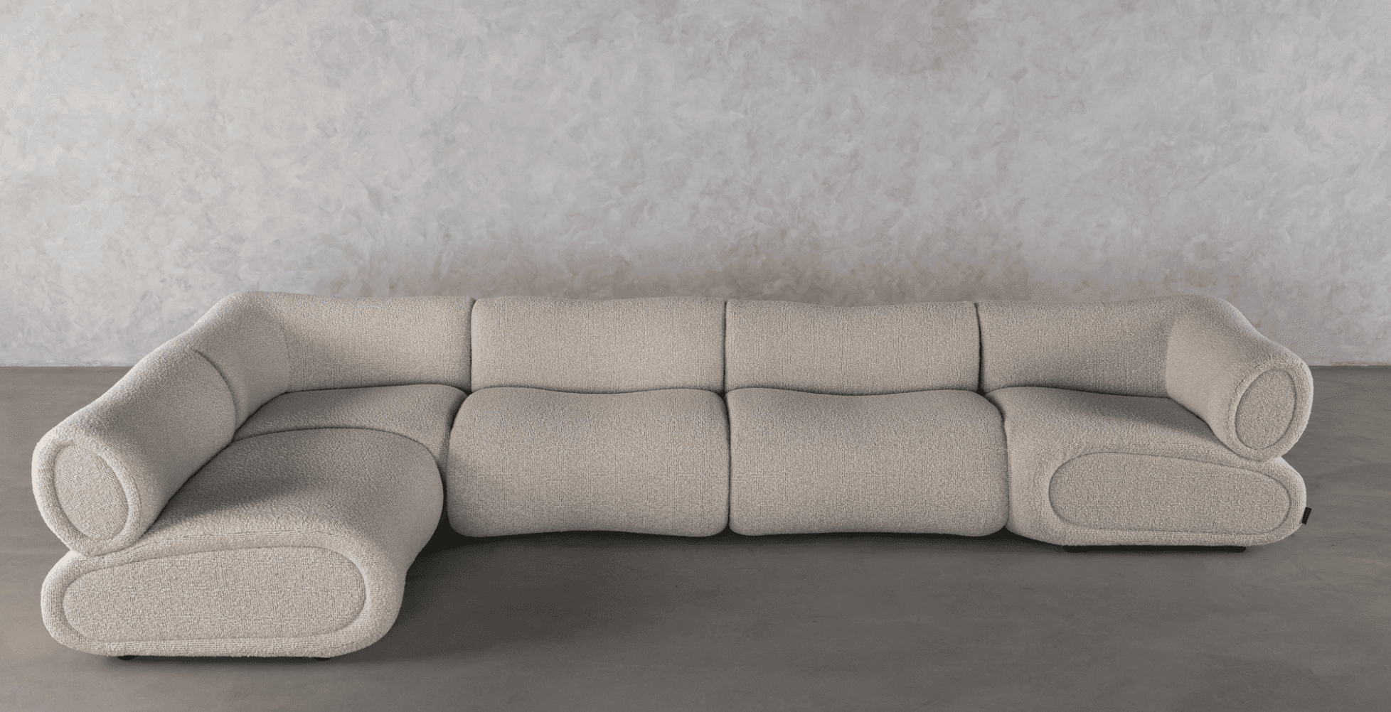 A modern, off-white bouclé fabric sectional sofa composed of multiple modules. It features rounded, soft edges and a low-profile design, creating a plush and inviting appearance. The individual sections include armless units, a corner unit, and an end unit with a distinctive rolled armrest. The upholstery has a textured, looped surface, contributing to its contemporary aesthetic. — 3D model