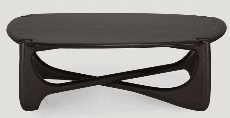 A low-slung coffee table featuring a dark, almost black, wood finish and a distinctively sculpted base. The tabletop is a rounded rectangle with soft edges, and the base consists of two interlocking, curved, and tapered forms that create an 'X' shape, providing a visually dynamic and stable foundation. — 3D model