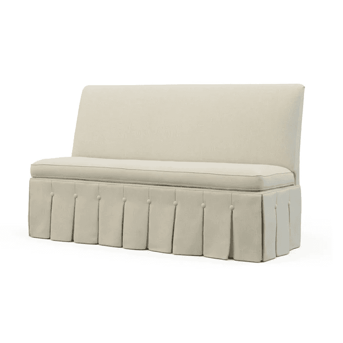 A cream-colored bench with a high back and a skirted base featuring inverted pleats and decorative b… — 3D model