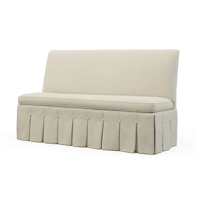 A cream-colored bench with a high back and a skirted base featuring inverted pleats and decorative buttons. The bench has a cushioned seat and backrest, upholstered in a textured fabric. — 3D model