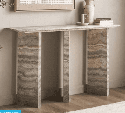 A long, narrow console table made entirely from a natural stone resembling travertine, characterized… — 3D model