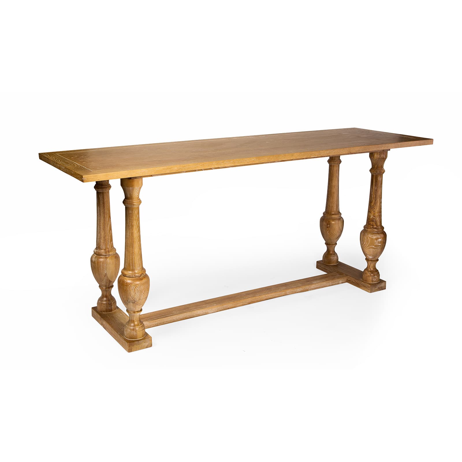 A long, narrow console table constructed from light-toned wood, featuring a rectangular top and supported by four elaborately turned legs. The legs are connected by a horizontal stretcher bar along the bottom, providing stability. The wood displays a visible grain and a rustic, natural finish. — 3D model