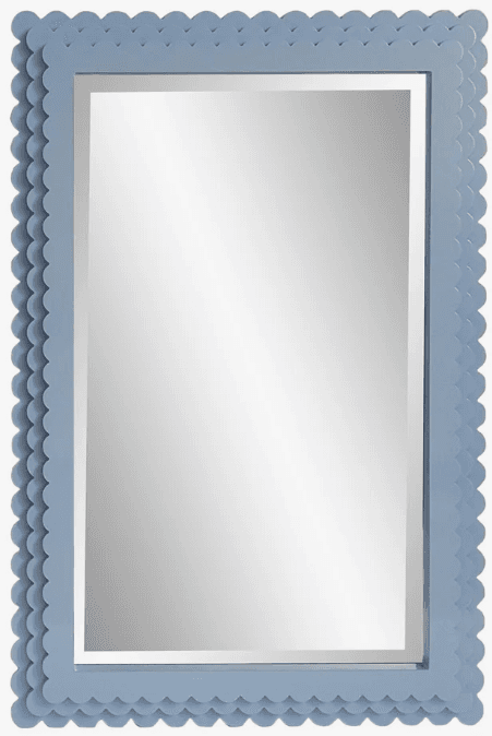 A rectangular wall mirror featuring a thick, light blue frame with a distinctive scalloped or bobble-like textured edge. The mirror is presented at an angle, highlighting the depth and decorative detail of its frame. — 3D model