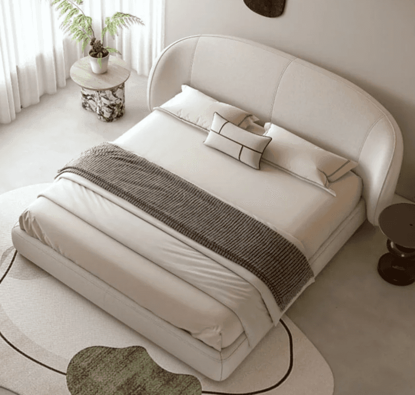 A contemporary upholstered bed with a curved headboard. The bed frame is low-profile and appears to… — free OBJ 3D model