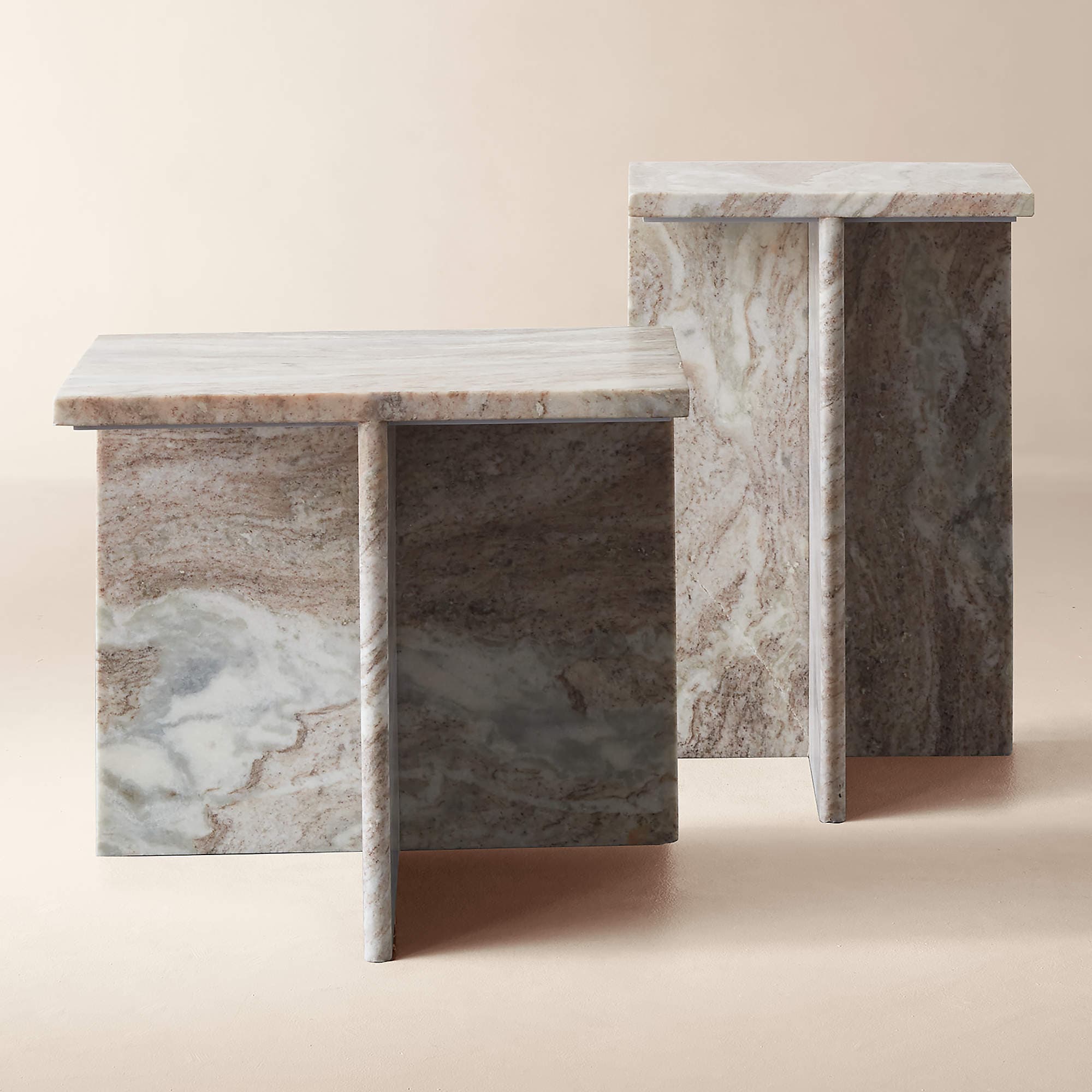 A set of two side tables, each constructed from marble. The tables have a rectangular top and a single, flat leg that appears to be integrated into the design. The marble exhibits a variegated pattern with tones of white, grey, and reddish-brown veining. The tables are positioned next to each other, with one slightly taller than the other. — 3D model