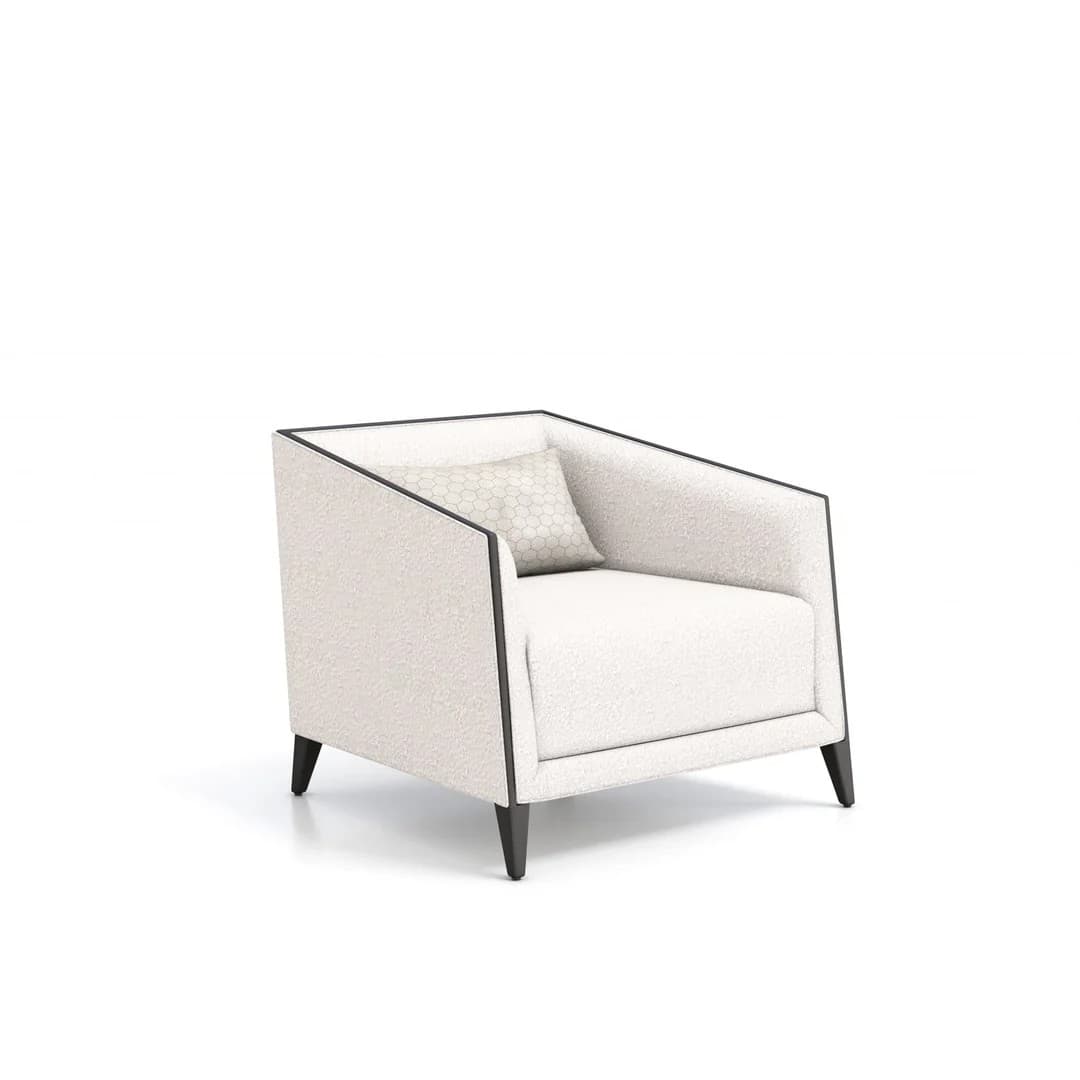 A contemporary armchair with a slightly reclined back and wide armrests. The upholstery has a textured, boucle-like finish. A small decorative cushion with a hexagonal pattern is placed on the seat. The armchair is supported by four dark, tapered legs and features a contrasting dark trim along its edges. — 3D model