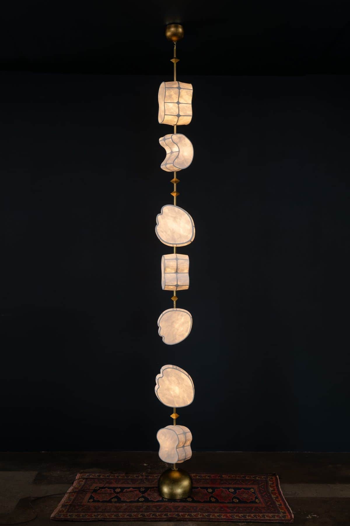 A tall, vertically oriented chandelier featuring multiple tiers of irregularly shaped diffusers made… — 3D model
