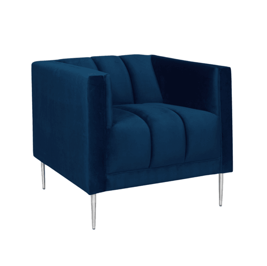 A modern accent armchair upholstered in deep navy blue velvet, featuring distinctive channel tufting on the backrest and seat. The chair has a boxy silhouette with square armrests and is supported by slender, tapered silver-toned metal legs. — 3D model