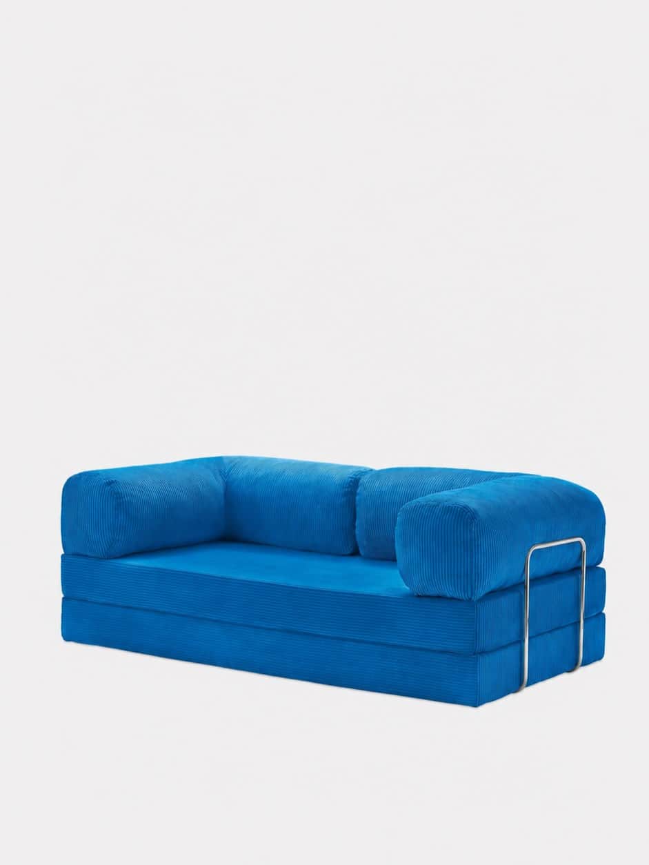 A vibrant blue modular sofa, upholstered in corduroy fabric, featuring a low-profile base composed o… — 3D model