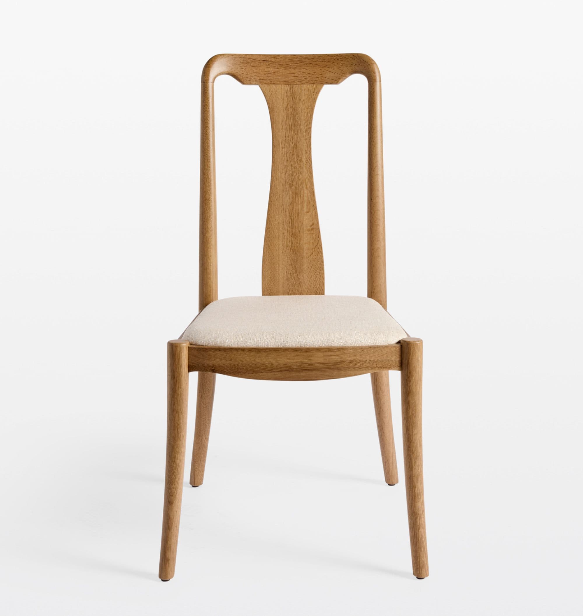 A modern dining chair constructed from light-toned oak wood with a distinctive T-shaped backrest and an upholstered seat cushion. The chair features a minimalist design with clean lines and gently curved elements. — 3D model
