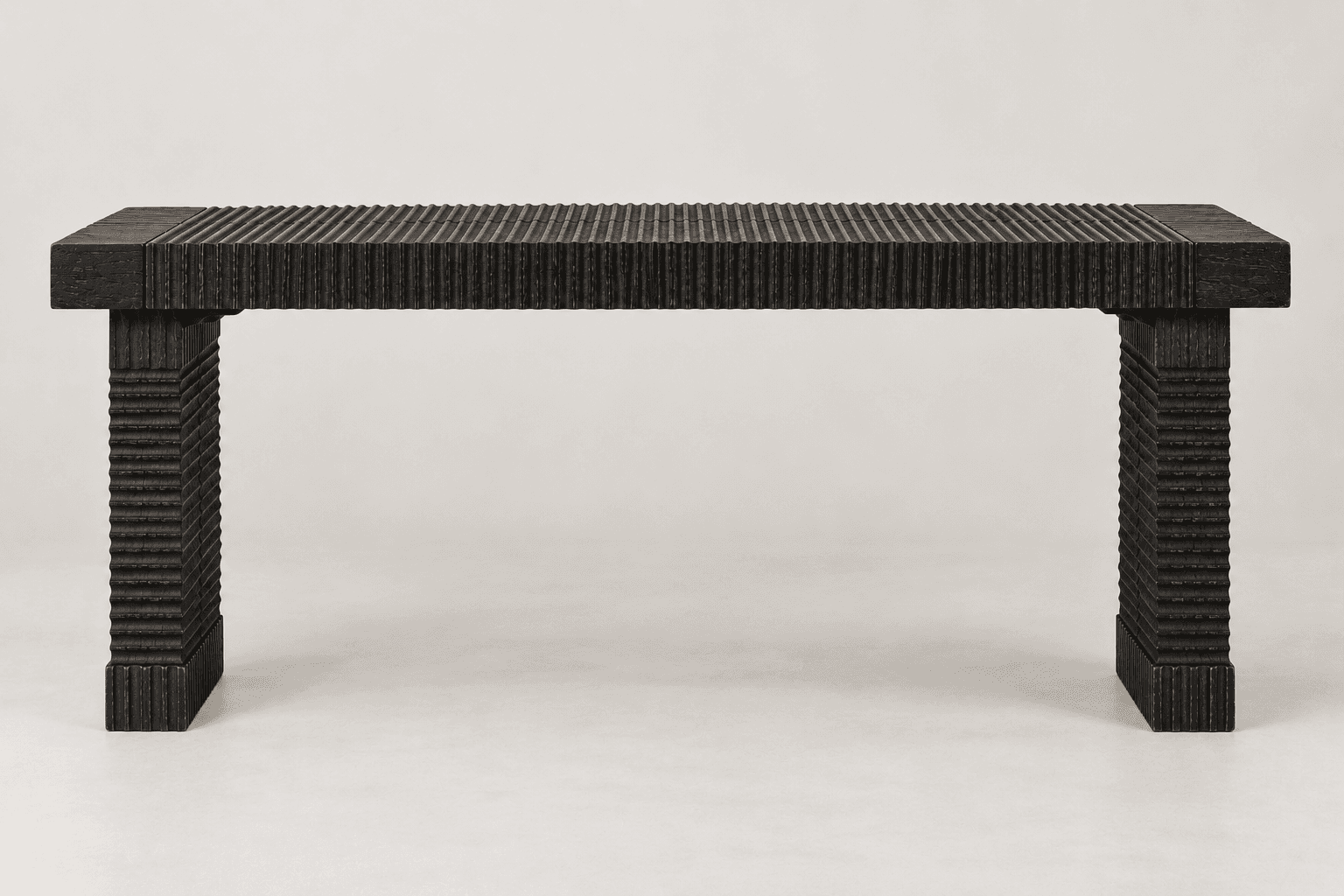A dark-colored, rectangular bench with a heavily textured, fluted surface, supported by two thick, rectangular legs. — 3D model