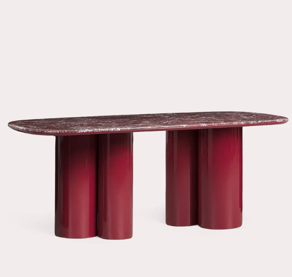 A contemporary console table featuring a rounded rectangular red marble top with white veining, supported by two sculptural deep red glossy lacquered cylindrical bases. — 3D model