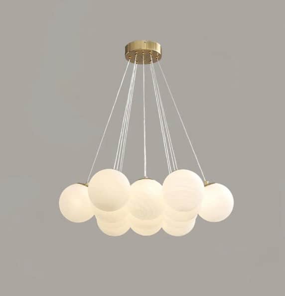 A modern multi-light chandelier featuring a circular brass canopy from which multiple white frosted… — 3D model