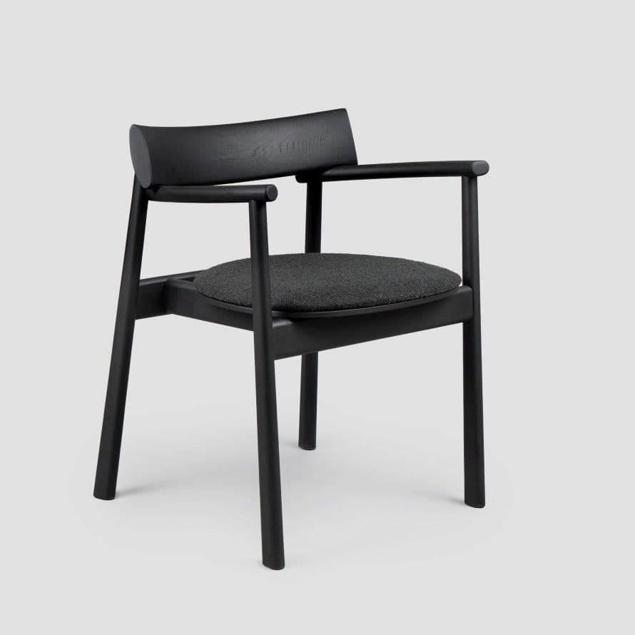 A modern dining armchair crafted from black stained wood, featuring an upholstered dark grey fabric seat and integrated armrests. — 3D model