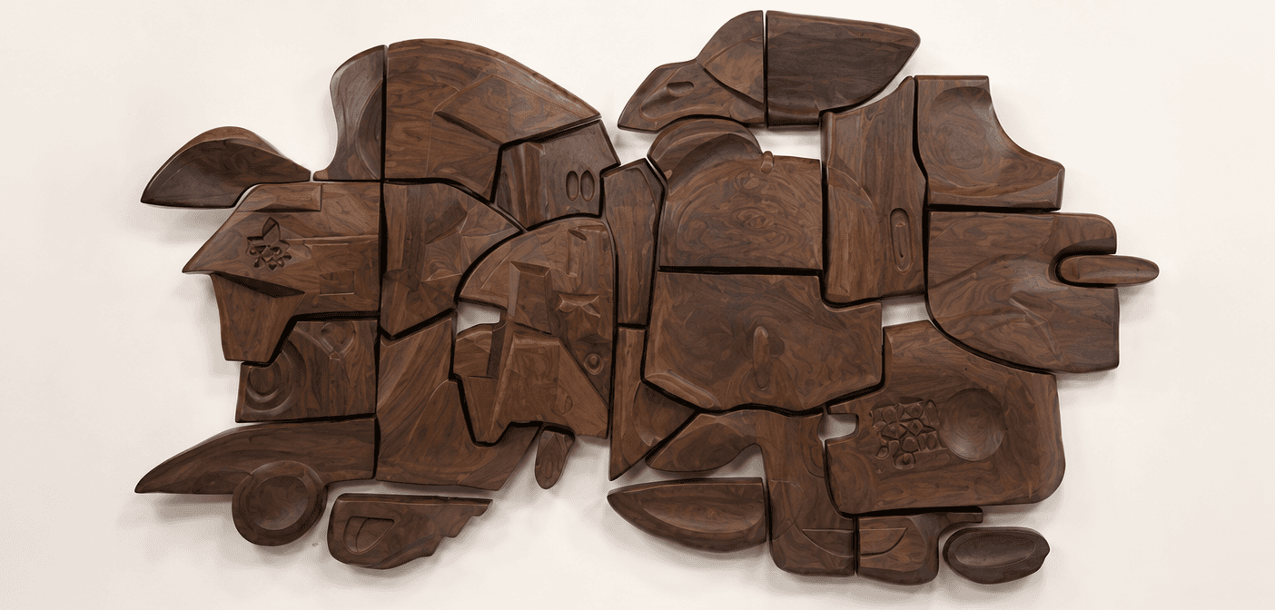 An abstract, wall-mounted sculpture composed of multiple interlocking segments of dark, richly grained wood. Each segment is uniquely carved with organic, fluid shapes and varying depths, creating a complex, three-dimensional relief. The pieces fit together to form a larger, irregular composition that evokes natural forms or a fragmented landscape. — 3D model