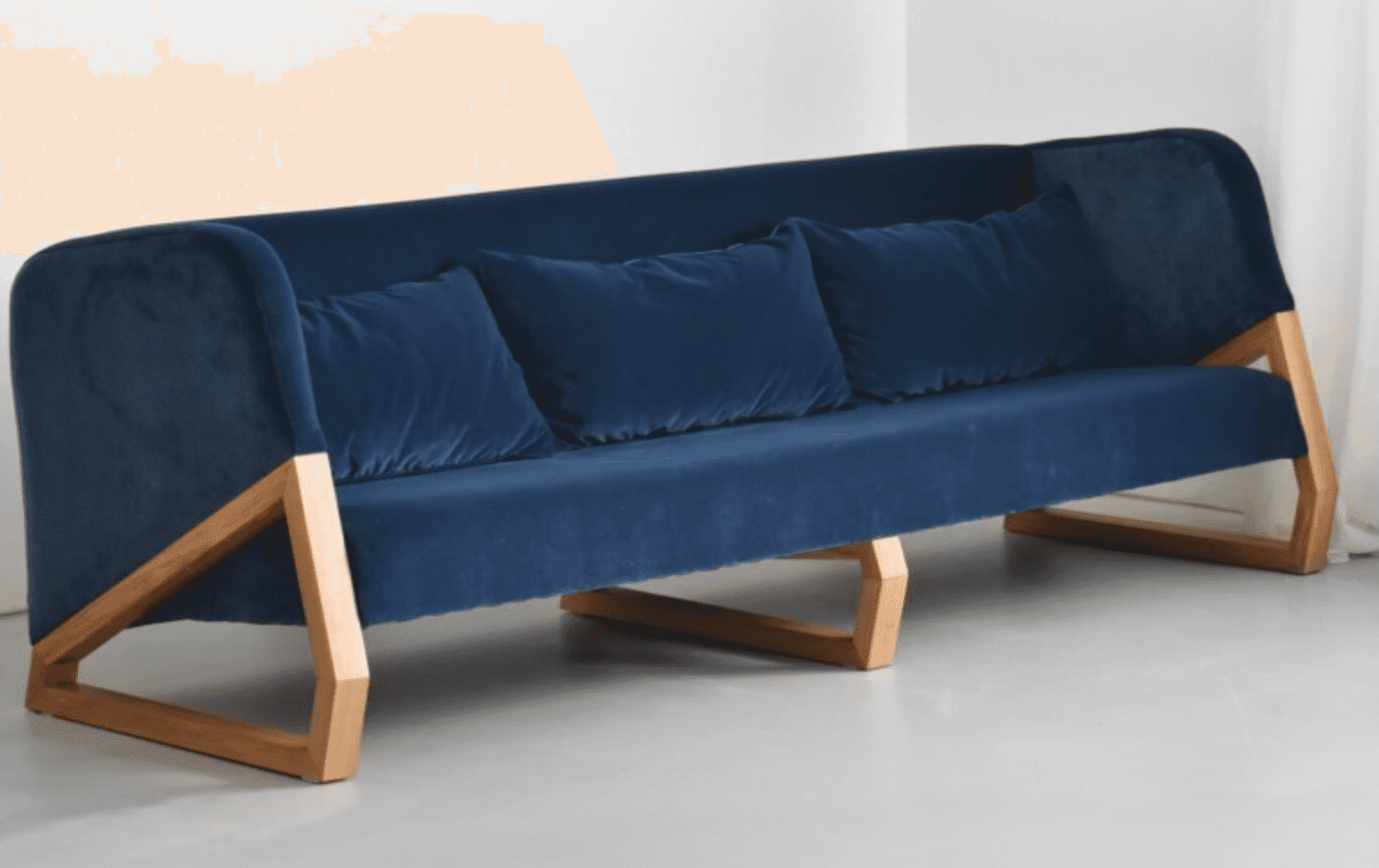 A modern sofa featuring deep blue fabric upholstery and a distinctive exposed light-toned wooden fra… — free GLB 3D model