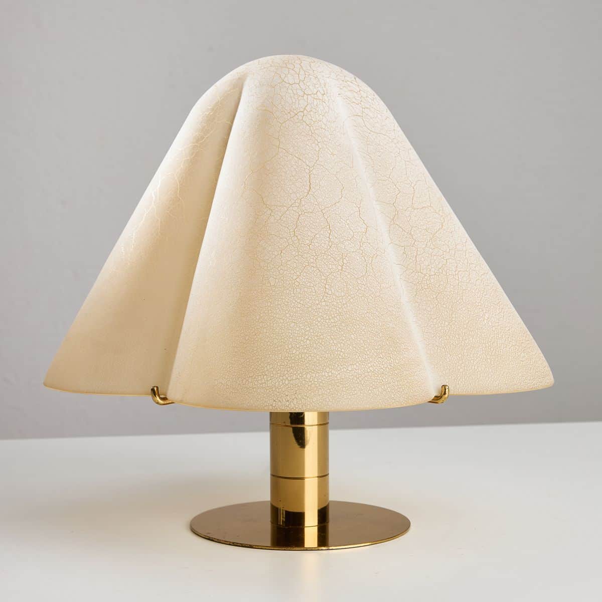 A table lamp with a unique, draped lampshade. The lampshade is a pale cream color with a crackled fi… — 3D model