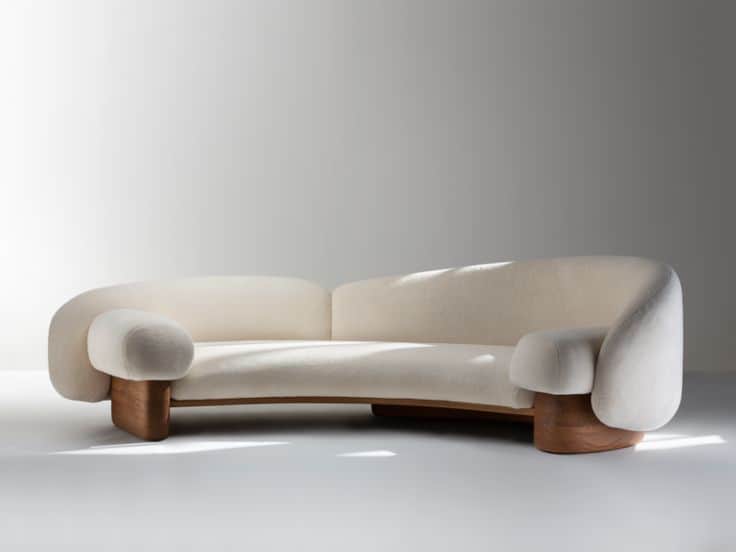 A modern, curved sofa featuring cream-colored bouclé upholstery and a distinctive, sculptural dark w… — 3D model