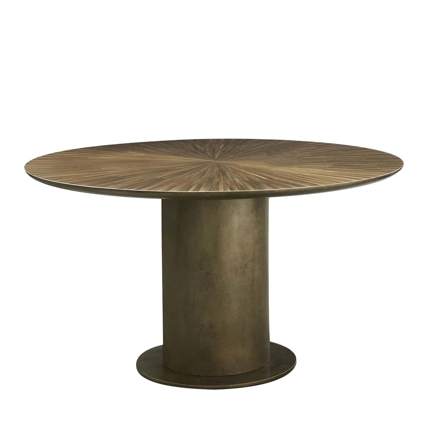 A round dining table featuring a distinctive starburst wood veneer top and a solid, cylindrical bronze-toned pedestal base. The tabletop exhibits a radial pattern of contrasting wood grains, emanating from the center. The base is simple and robust, anchored by a round metal plate that matches the pedestal's finish. — 3D model
