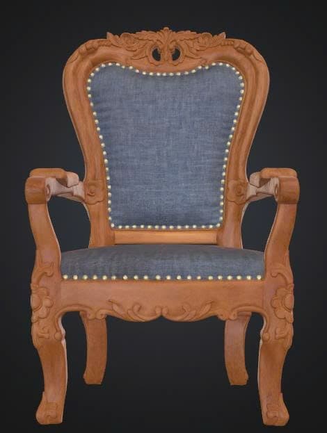 An ornate armchair featuring a carved wooden frame with intricate floral and scroll motifs, upholstered in a blue fabric on the seat and back, accented with brass nailhead trim. The chair has curved armrests and cabriole legs, indicative of historical European design. — 3D model