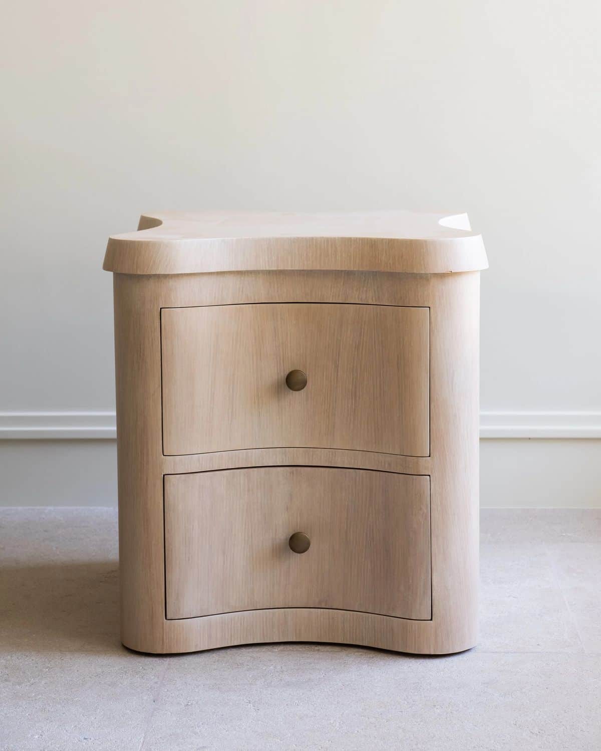 A light-colored wooden cabinet with a distinctive wavy-edged top and two curved drawers, featuring s… — 3D model