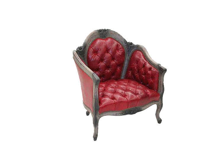 A vintage red armchair with tufted upholstery and a decorative carved frame. The armchair features a… — 3D model