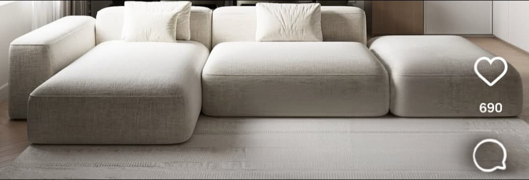 A light beige, contemporary modular sectional sofa. The configuration includes a chaise lounge section, an armless seating module, a corner module with backrests, and two separate ottoman-style modules. All pieces are upholstered in a light-colored, textured fabric, featuring soft, rounded edges and a low-profile design, suggesting a modern and minimalist aesthetic. — 3D model