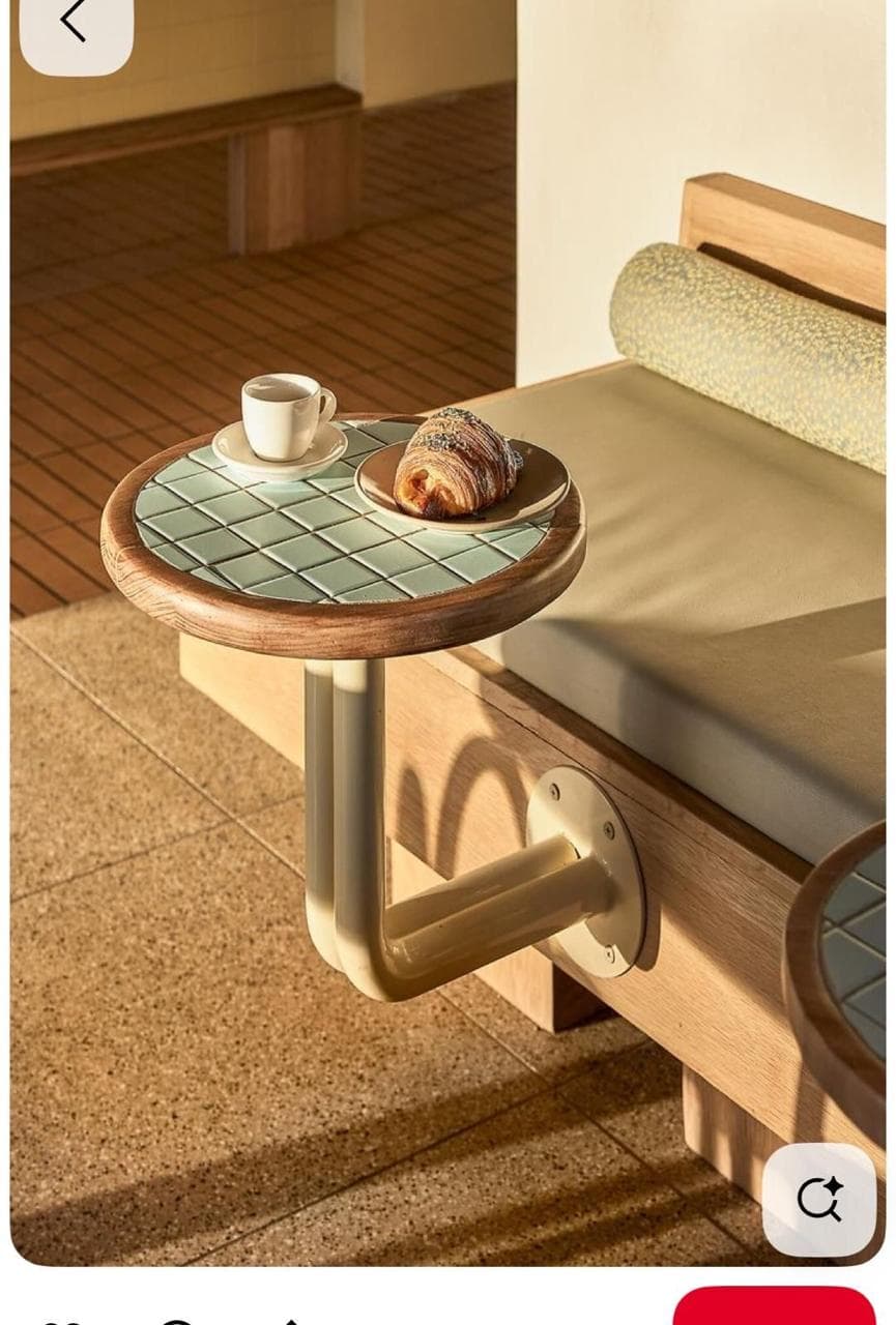 A small, round wall-mounted accent table featuring a wooden rim and an inlaid surface of small, light green square tiles. The table is supported by a curved, tubular metal arm that attaches to the wall via a circular mounting plate. — 3D model