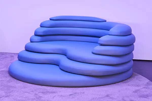 A large, low-profile sofa with a unique, tiered, organic design. The sofa features multiple rounded,… — free GLTF 3D model