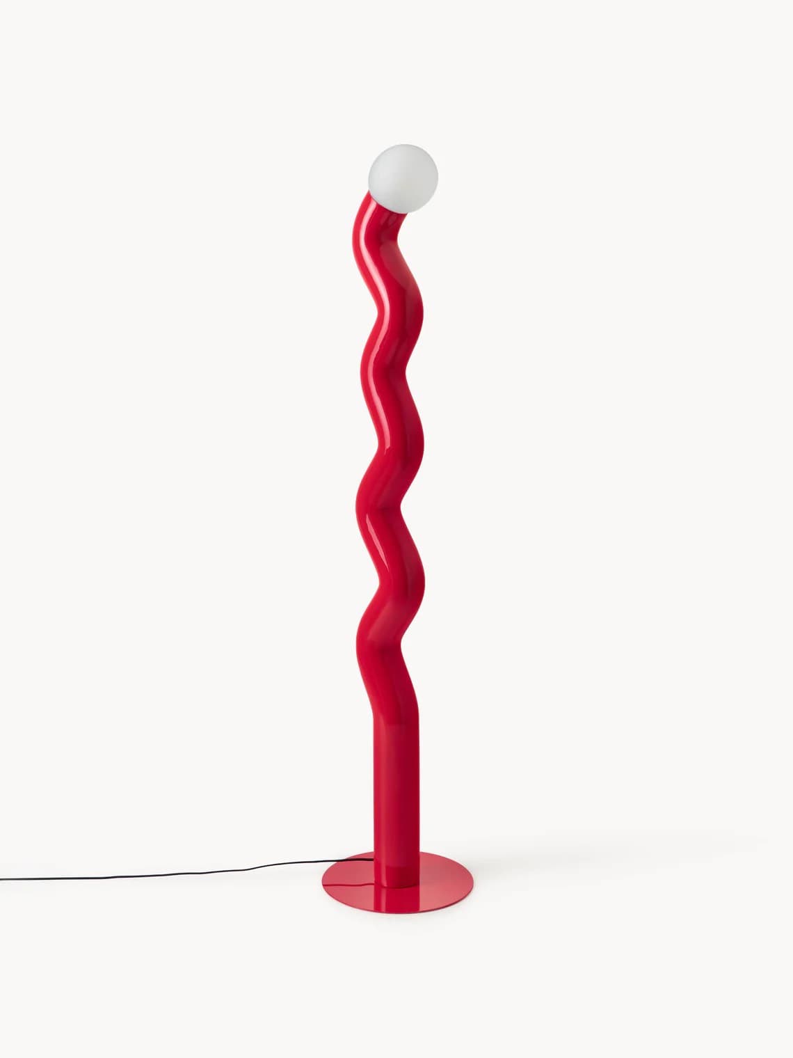 A tall, red floor lamp with a serpentine-shaped body. The lamp features a wavy, organic form that twists upwards, terminating in a spherical white light fixture at the top. It stands on a circular red base with a black power cord extending to the left. — 3D model