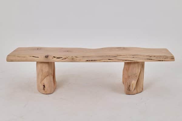 A rustic coffee table constructed from natural wood elements. The tabletop is a single slab with a l… — 3D model