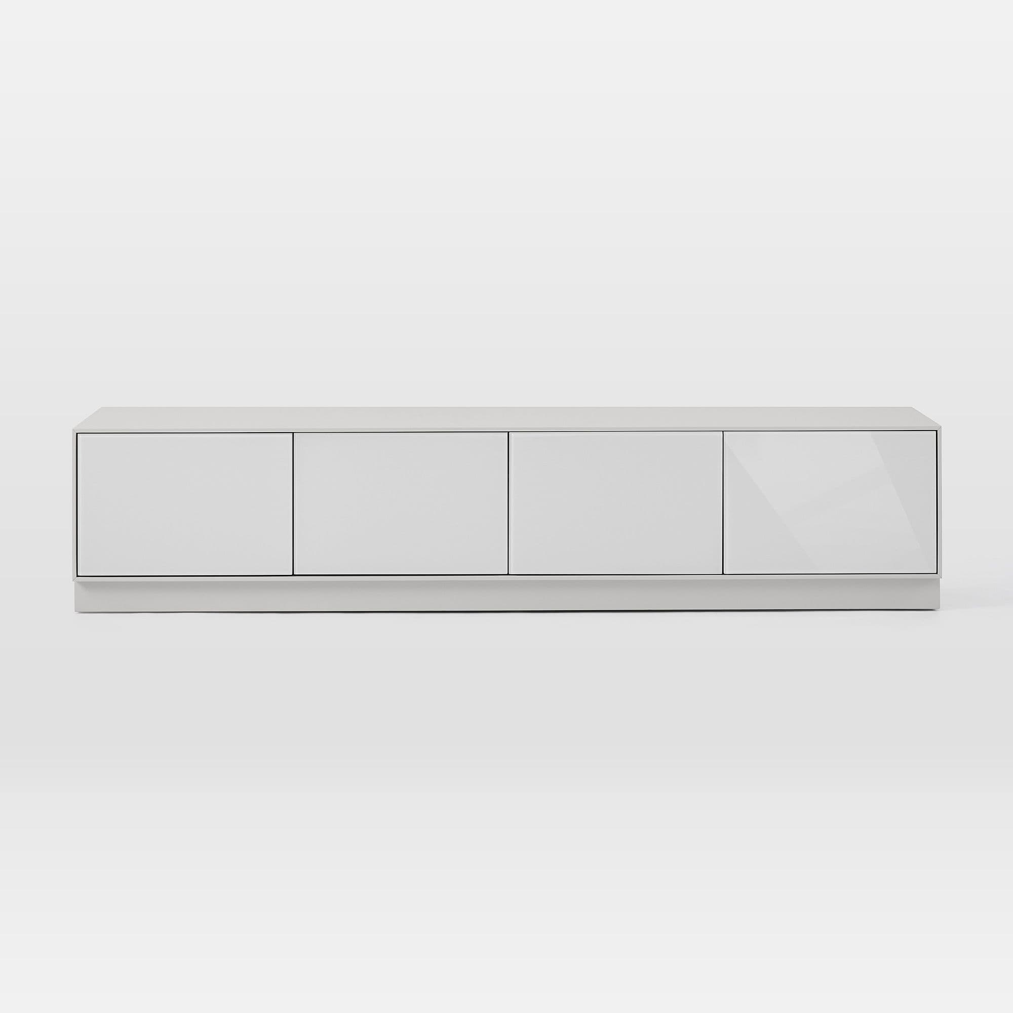 A sleek, modern media console with a low-profile design, featuring four equally sized, handle-less doors for storage. The unit is finished in a light gray or off-white hue, with the doors appearing to have a glossy or lacquered finish, contrasting with a potentially matte finish on the top surface and base. It rests on a discreet plinth base, contributing to its minimalist aesthetic. The clean lines and flush-fitting doors emphasize contemporary design. — 3D model