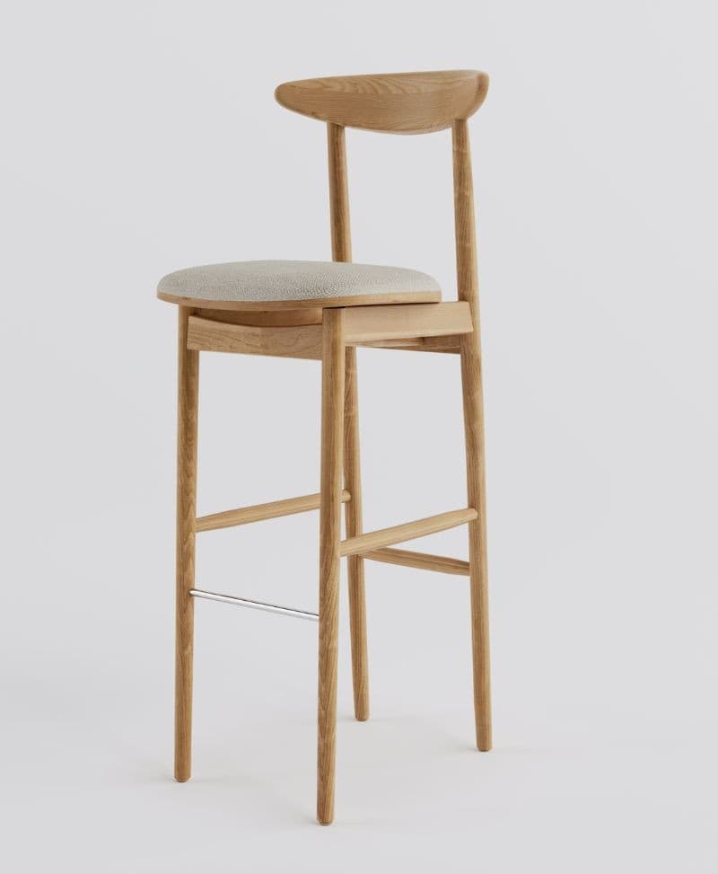 A modern bar stool crafted from light oak wood, featuring a round upholstered seat in light beige fabric, a low curved wooden backrest, and slender tapered legs with a chrome-plated steel footrest bar. — 3D model