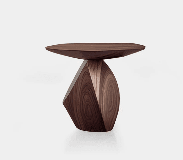 A modern accent table crafted from dark walnut wood, featuring a thin, oval-shaped top and a unique, sculptural, faceted base with visible wood grain. — 3D model