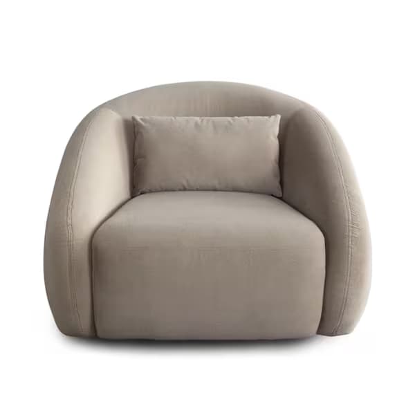 A modern, round club chair, fully upholstered in a light beige fabric, featuring a deep seat and integrated, enveloping armrests and backrest. A small rectangular lumbar pillow in the same fabric is included for added comfort. The chair has a sleek, minimalist design with no visible legs, giving it a monolithic appearance. — 3D model