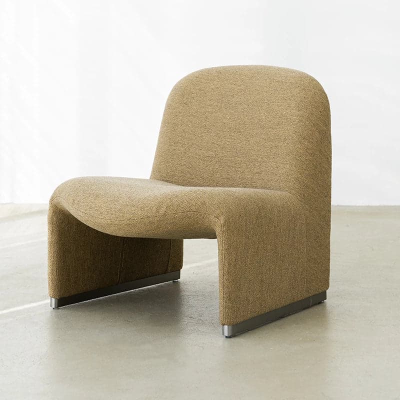 A contemporary lounge chair with a unified, curved form. The chair features a high, rounded back that flows seamlessly into the seat and arms. It rests on a low-profile base that appears to be made of metal, providing a stable foundation. The upholstery has a textured weave. — 3D model