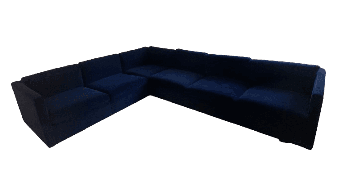 A dark blue, multi-seat sectional sofa with a low profile and blocky arms. It appears to be upholstered in a soft fabric, possibly velvet, and is configured in an L-shape. — 3D model