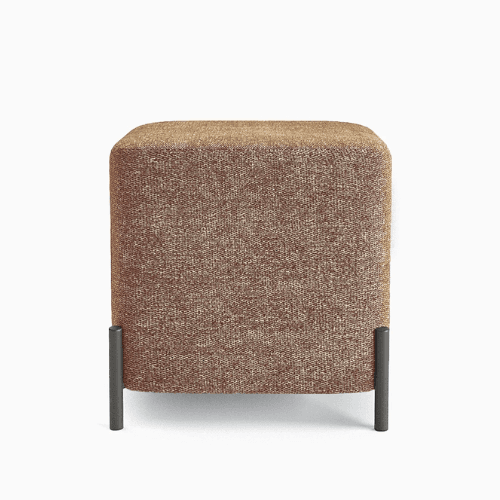 A square-shaped ottoman with rounded edges, upholstered in a textured fabric. It is supported by four slender, cylindrical legs positioned at the corners, extending slightly beyond the base. — 3D model