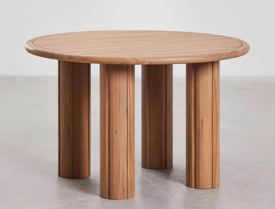 A round wooden coffee table with four thick, cylindrical legs. The tabletop has a slatted surface an… — 3D model